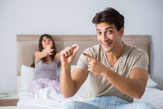 A happy man and his partner about to take ED medication for a night of pleasure